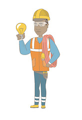 Image showing Young african electrician holding a lightbulb.