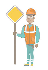 Image showing Young hispanic road worker showing road sign.