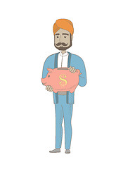 Image showing Hindu businessman holding a piggy bank.