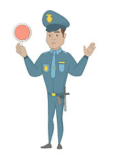 Image showing Hispanic traffic policeman holding traffic sign.