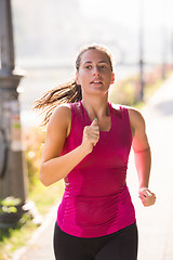 Image showing woman jogging at sunny morning