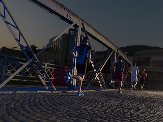 Image showing young people jogging across the bridge