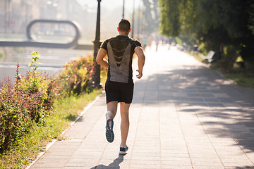 Image showing man jogging at sunny morning