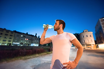 Image showing man drinking water after running session