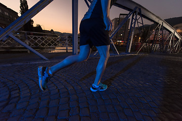 Image showing man jogging across the bridge in the city