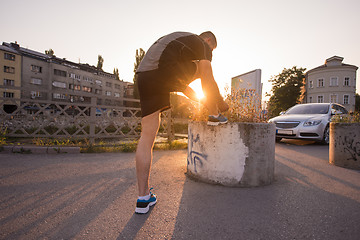 Image showing man tying running shoes laces