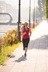 Image showing woman jogging at sunny morning