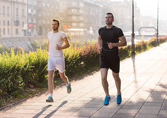 Image showing group of young people jogging in the city