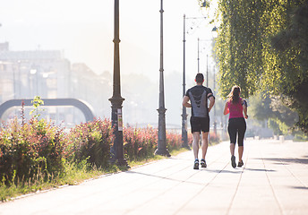 Image showing young couple jogging  in the city