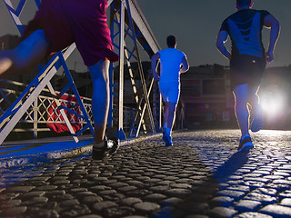 Image showing young people jogging across the bridge