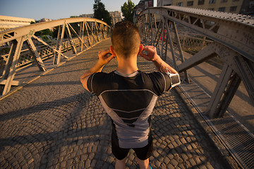 Image showing portrait of a jogging man at sunny morning