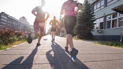 Image showing group of young people jogging in the city