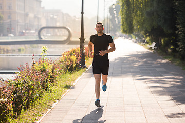 Image showing man jogging at sunny morning