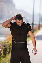 Image showing man pouring water from bottle on his head