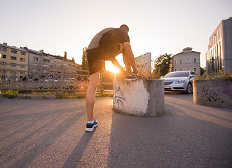 Image showing man tying running shoes laces