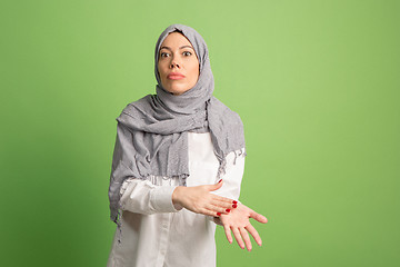 Image showing Argue, arguing concept. arab woman in hijab. Portrait of girl, posing at studio background