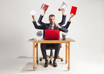 Image showing businessman with many hands in elegant suit working with paper, document, contract, folder, business plan.