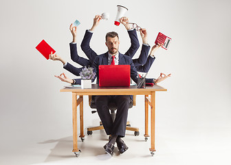 Image showing businessman with many hands in elegant suit working with paper, document, contract, folder, business plan.