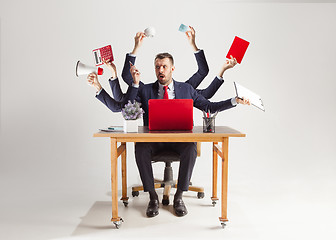 Image showing businessman with many hands in elegant suit working with paper, document, contract, folder, business plan.