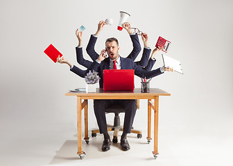 Image showing businessman with many hands in elegant suit working with paper, document, contract, folder, business plan.