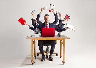 Image showing businessman with many hands in elegant suit working with paper, document, contract, folder, business plan.