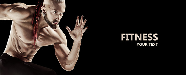 Image showing Man doing weight lifting in gym on black background.