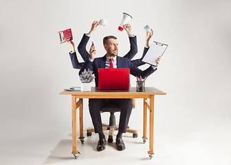 Image showing businessman with many hands in elegant suit working with paper, document, contract, folder, business plan.