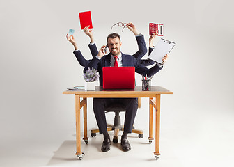 Image showing businessman with many hands in elegant suit working with paper, document, contract, folder, business plan.
