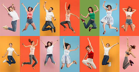 Image showing Freedom in moving. Pretty young woman jumping against orange background