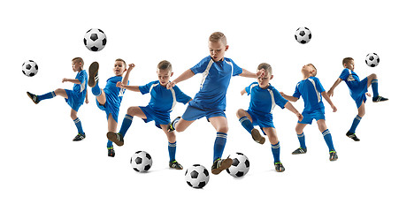 Image showing Young boy with soccer ball doing flying kick