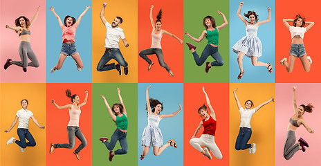 Image showing Freedom in moving. Pretty young woman jumping against orange background