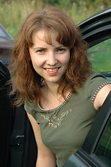 Image showing Portrait of the lovely girl leaving the car