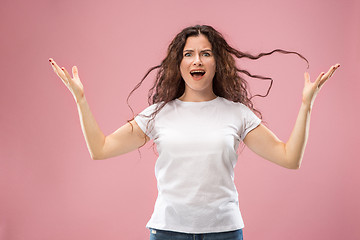 Image showing Portrait of an angry woman looking at camera isolated on a pink background