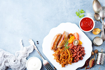 Image showing sausages with fried cabbage