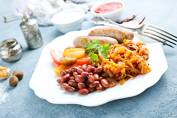 Image showing sausages with fried cabbage