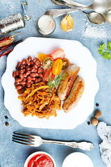 Image showing sausages with fried cabbage