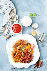 Image showing sausages with fried cabbage