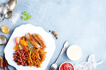 Image showing sausages with fried cabbage