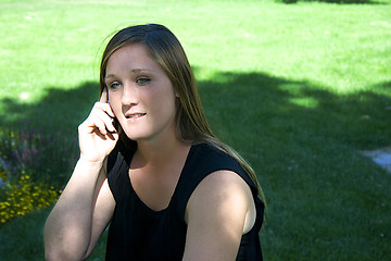 Image showing Beautiful Girl in the Park in a Black Dress Talking on the Phone