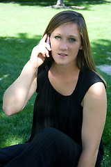 Image showing Beautiful Girl in the Park in a Black Dress Talking on the Phone