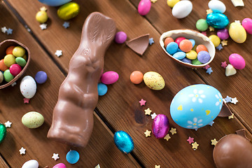 Image showing chocolate eggs, easter bunny and candies on wood