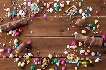 Image showing chocolate eggs, easter bunnies and candies on wood