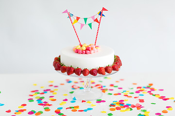 Image showing close up of birthday cake with garland on stand