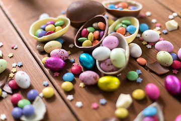 Image showing chocolate eggs and candy drops on wooden table