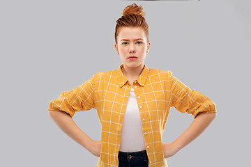 Image showing serious red haired teenage girl with hands on hips