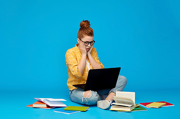 Image showing stressed student girl with laptop and books