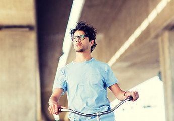 Image showing young hipster man riding fixed gear bike