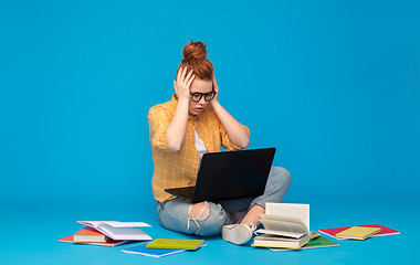 Image showing stressed student girl with laptop and books