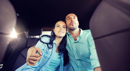 Image showing happy man and woman hugging on taxi back seat