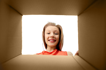 Image showing happy surprised girl looking into gift box